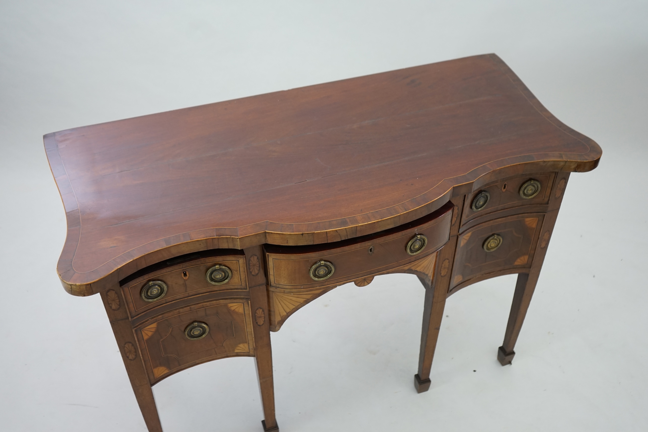 A George III inlaid mahogany serpentine sideboard